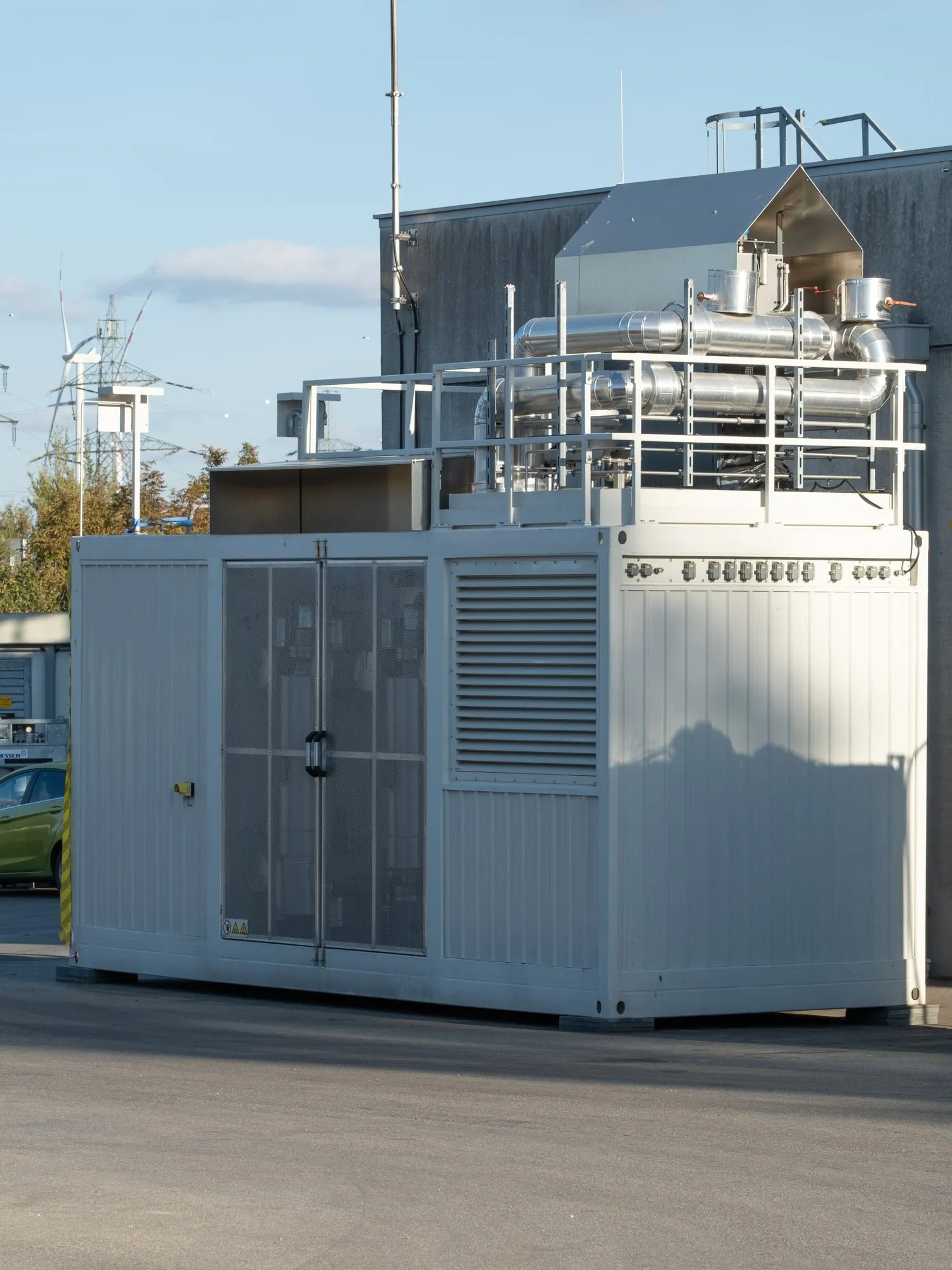 Die 200-kW-Pilotanlage von CAIROS in Bruck an der Leitha: ein Container mit Prozesstechnik, auf dem Dach isolierte Rohrleitungen